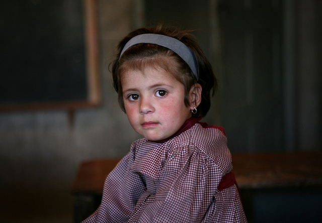 A girl from a school supported by Hashoo Foundation looks on.
