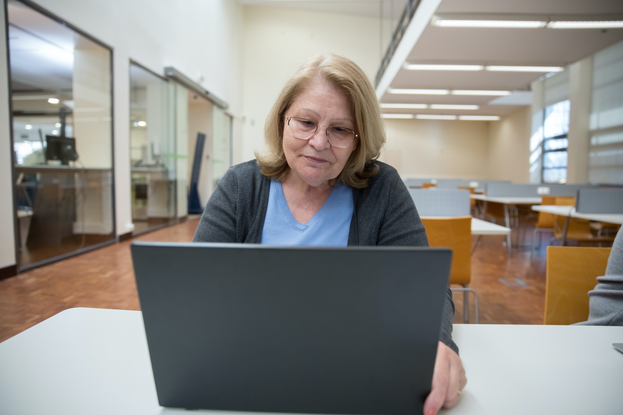 A teacher looking at a laptop screen