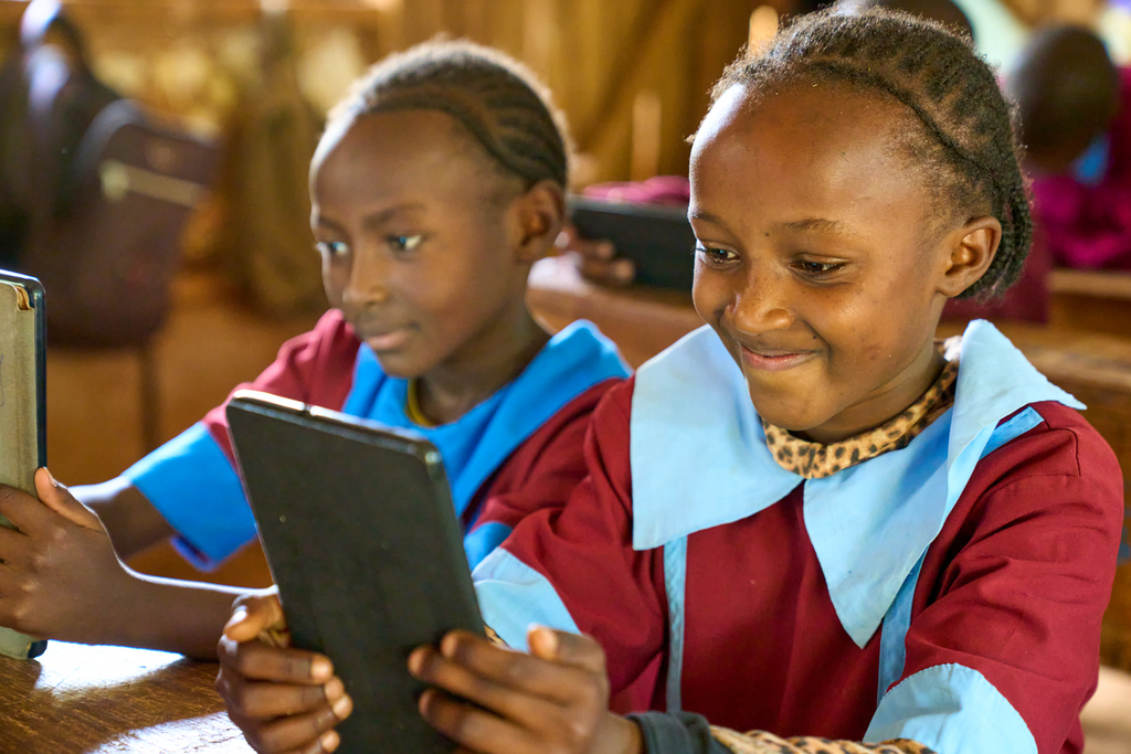 Two girls on their tablets